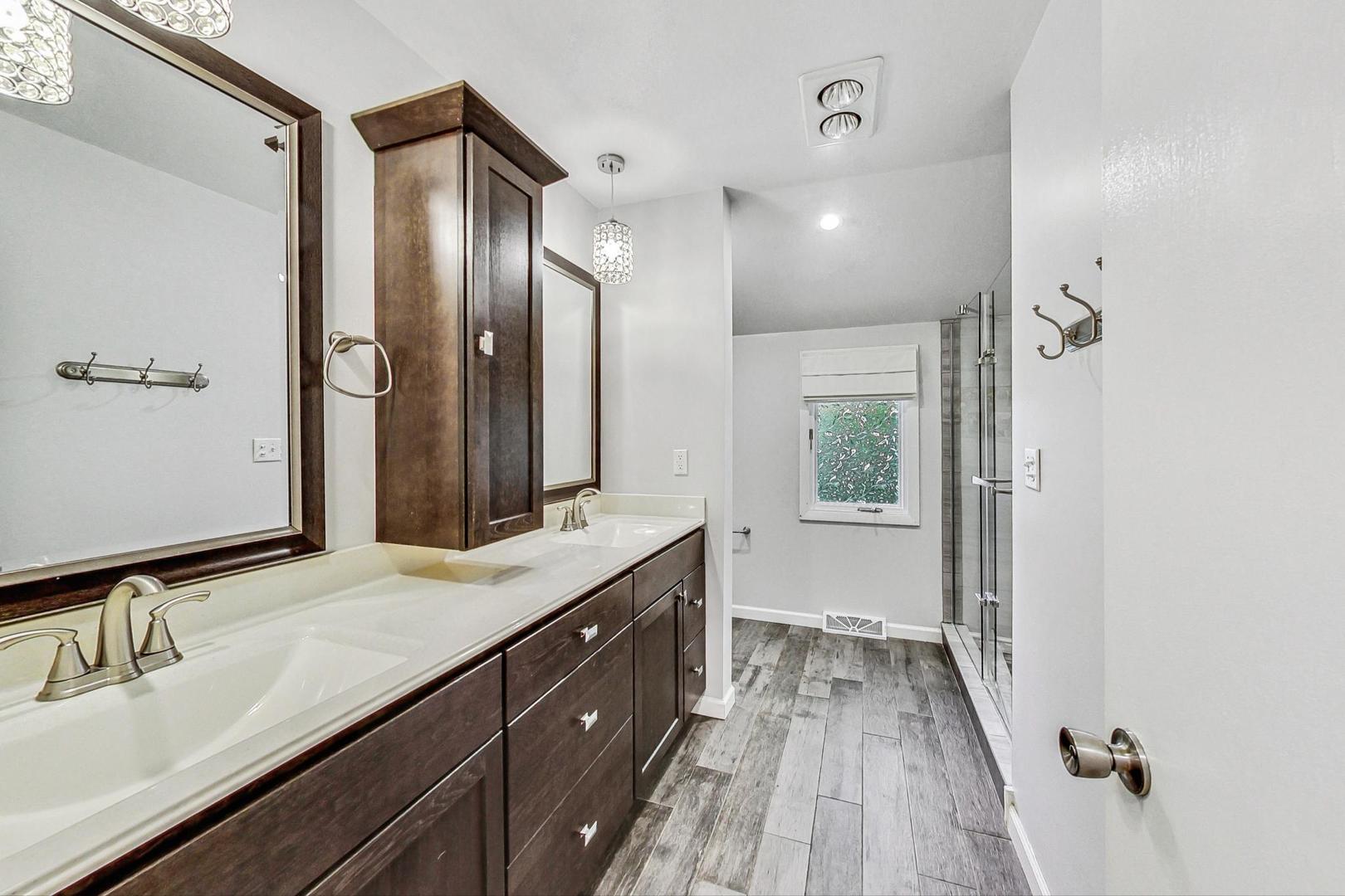 311 Deerpath Drive Winthrop Harbor, IL 60096 - Photo 21 of 48 a bathroom with a sink double vanity granite tub shower and a mirror