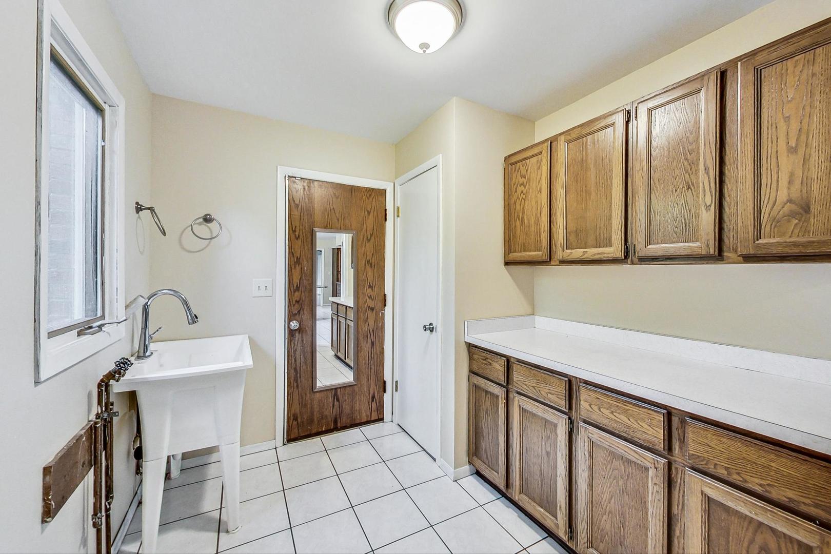 311 Deerpath Drive Winthrop Harbor, IL 60096 - Photo 32 of 48 a room with a sink cabinets and utility