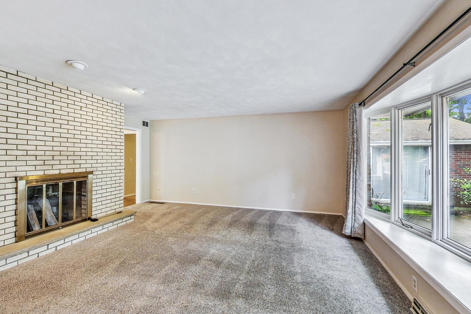 311 Deerpath Drive Winthrop Harbor, IL 60096 - Photo 7 of 48 a view of an empty room with a fireplace