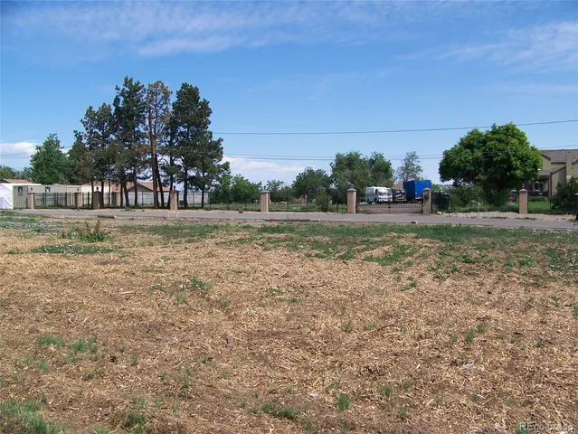 a front view of a house with a yard and street