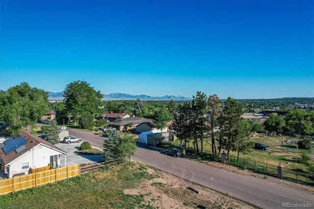 an aerial view of residential houses with outdoor space and street view