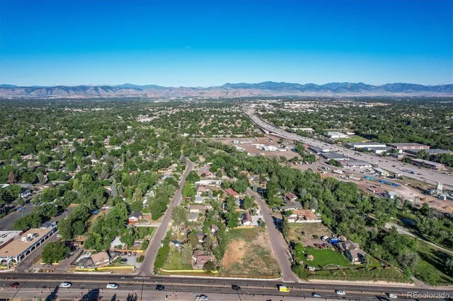 an aerial view of residential houses with outdoor space and mountain view