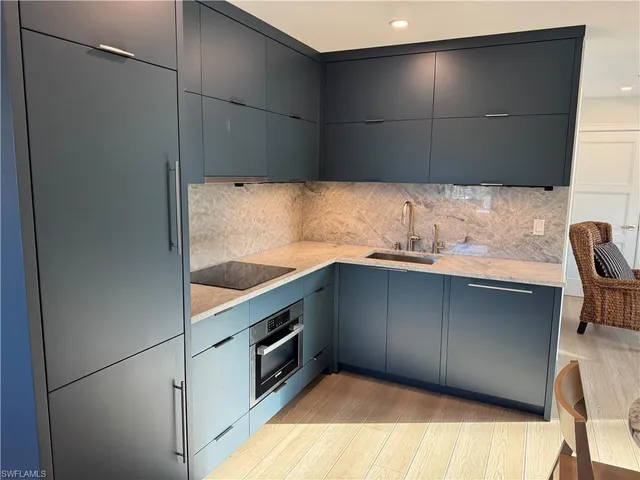 a kitchen with a sink and a refrigerator