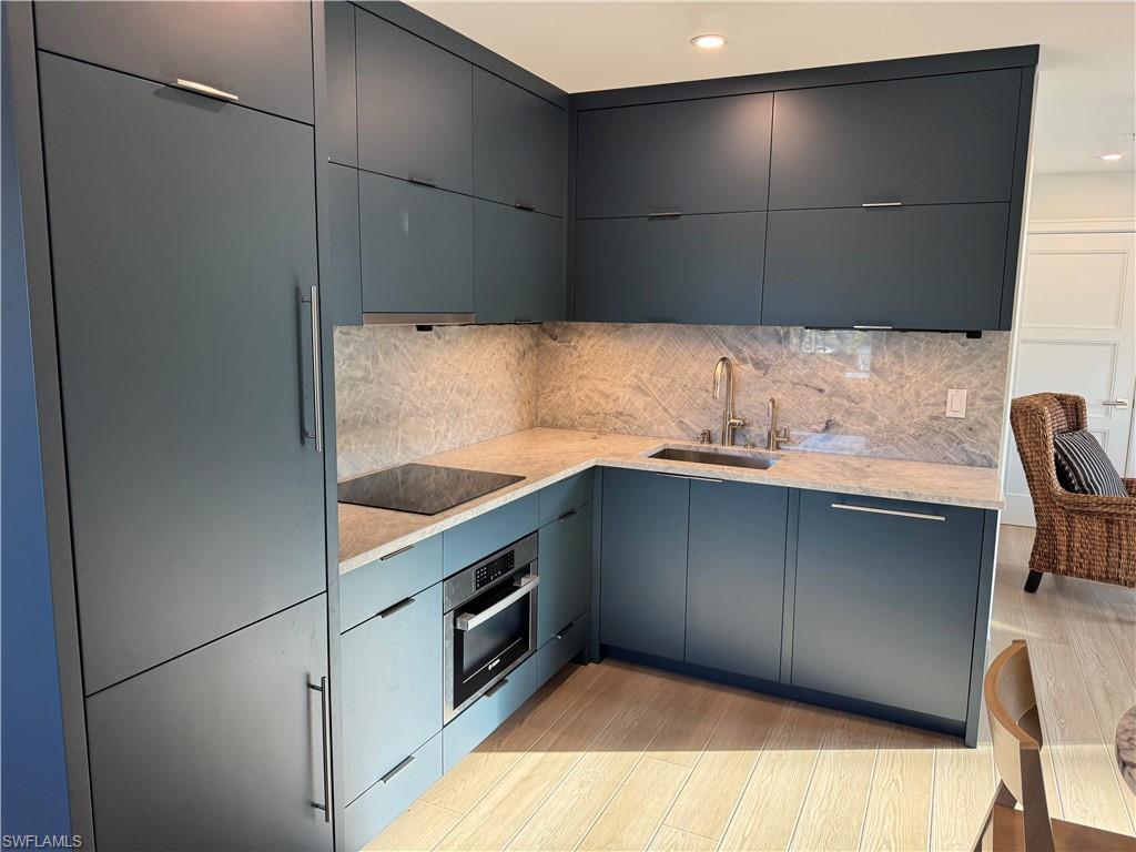 a kitchen with a sink and a refrigerator