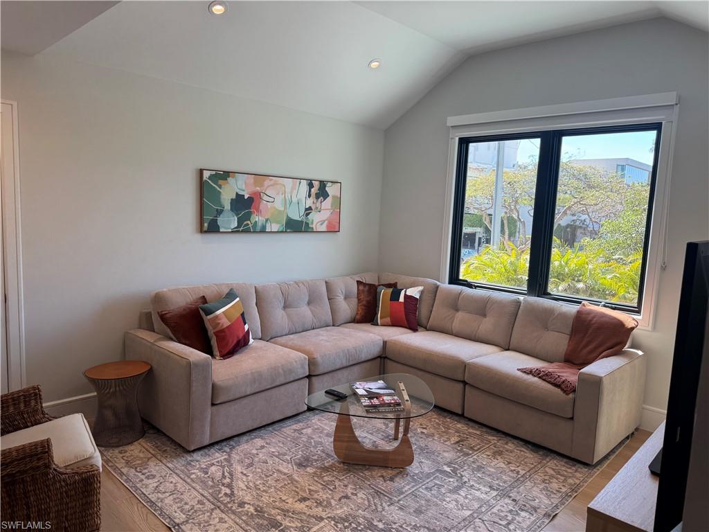 787 4th Avenue South Naples, FL 34102 - Photo 2 of 15 Living room featuring lofted ceiling, baseboards, wood finished floors, and recessed lighting