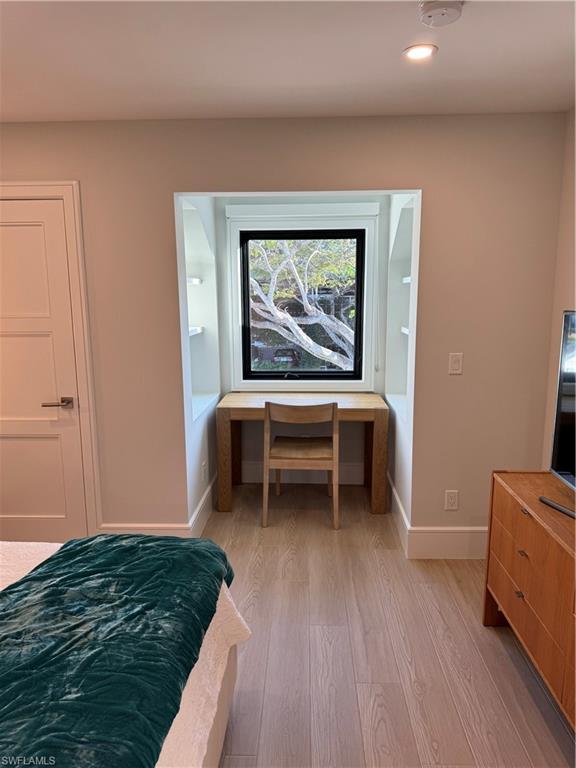 787 4th Avenue South Naples, FL 34102 - Photo 7 of 15 Bedroom with connected bathroom and light hardwood / wood-style flooring