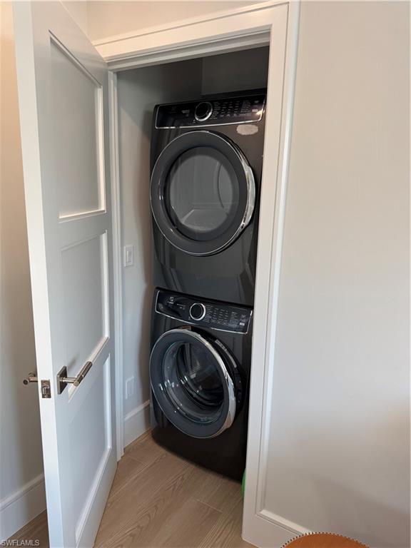 787 4th Avenue South Naples, FL 34102 - Photo 8 of 15 Private Laundry room featuring light hardwood / wood-style floors and stacked washer / drying machine