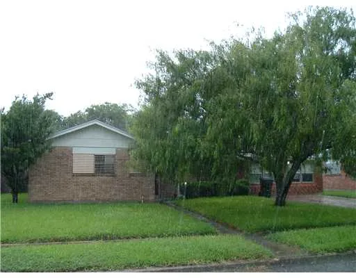 a view of a backyard with large trees