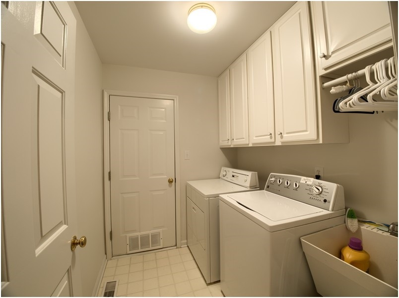 8501 Bluebill Court Raleigh, NC 27615 - Photo 24 of 25 Large laundry room with cabinets, sink, and drying area. Laundry room