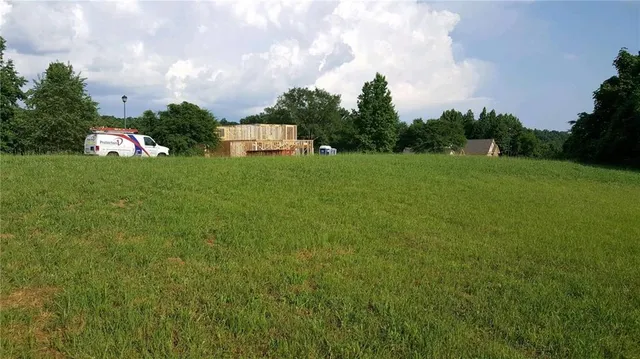 a front view of a house with a yard and trees