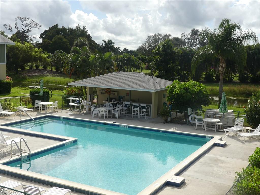 5501 Rattlesnake Hammock Road, Unit 1002 Naples, FL 34113 - Photo 2 of 9 swimming pool view with a seating space and a garden view