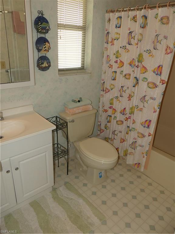 5501 Rattlesnake Hammock Road, Unit 1002 Naples, FL 34113 - Photo 5 of 9 a bathroom with a toilet and a sink