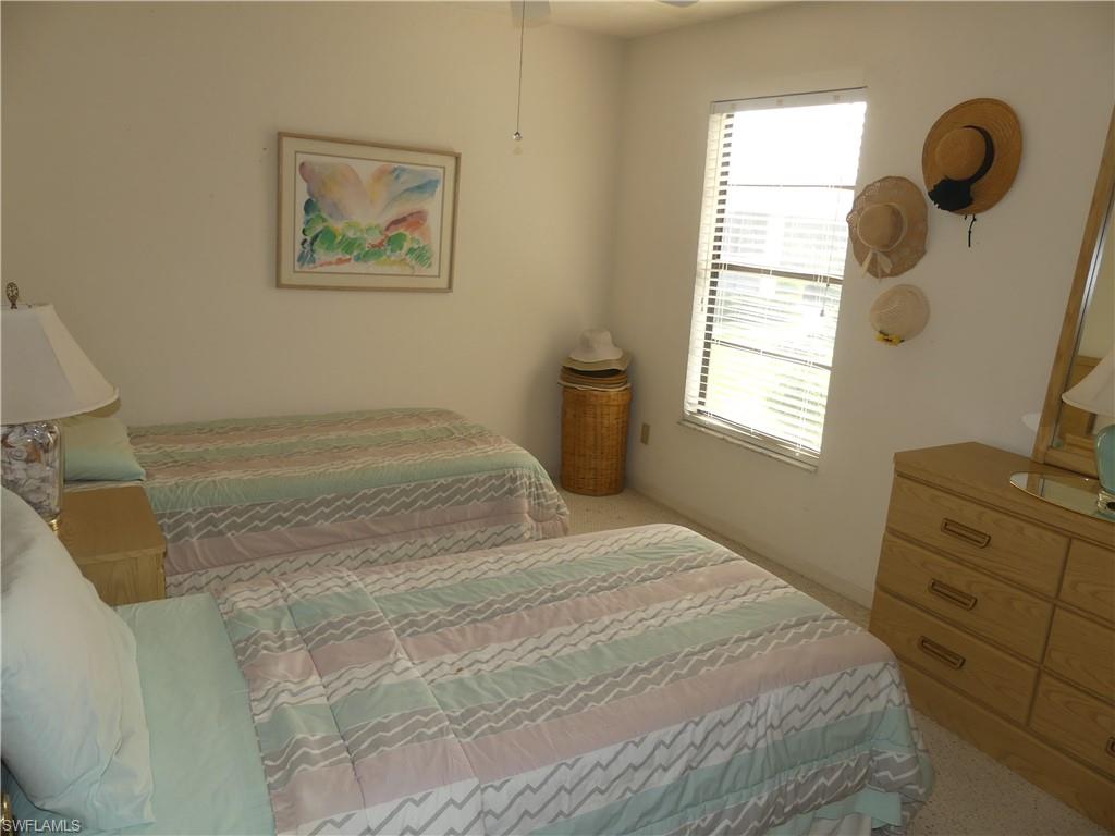 5501 Rattlesnake Hammock Road, Unit 1002 Naples, FL 34113 - Photo 6 of 9 a bedroom with a bed and a window