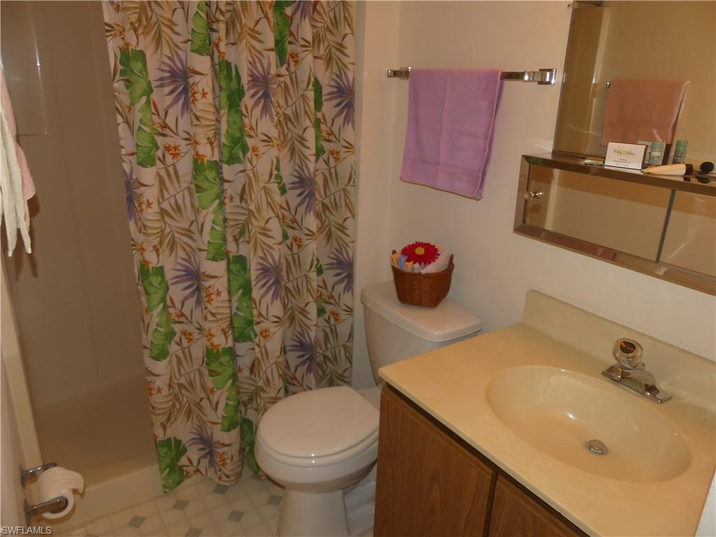 5501 Rattlesnake Hammock Road, Unit 1002 Naples, FL 34113 - Photo 7 of 9 a bathroom with a sink and a toilet