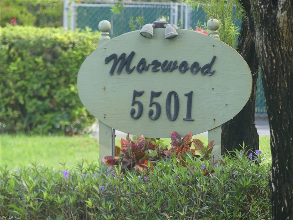 5501 Rattlesnake Hammock Road, Unit 1002 Naples, FL 34113 - Photo 9 of 9 a view of a wooden fence and some plants