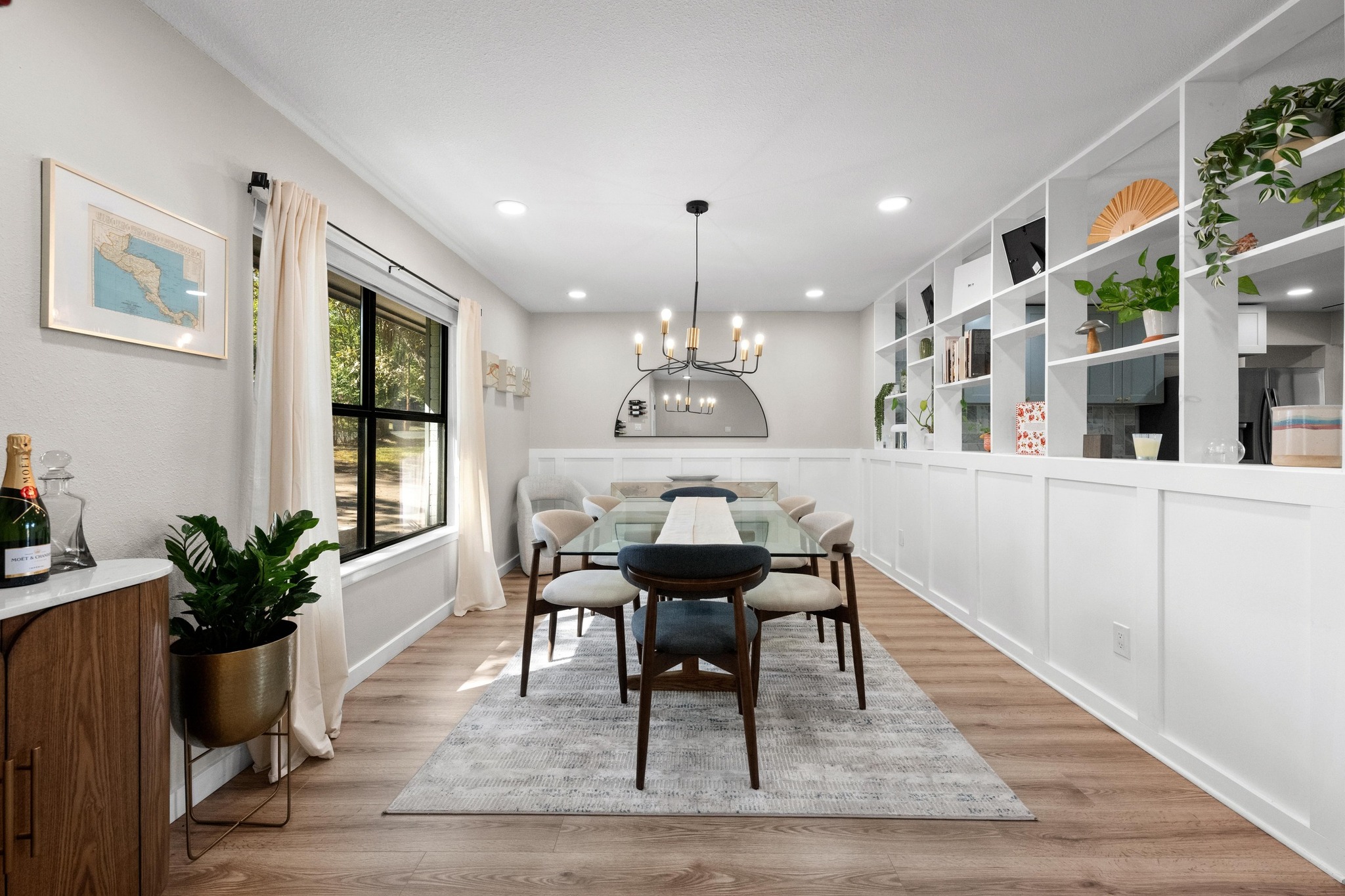 1006 Hollybluff Street Austin, TX 78753 - Photo 6 of 27 Dining area with light wood finished floors, a chandelier, recessed lighting, wainscoting, and a decorative wall