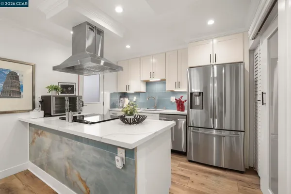 a kitchen with stainless steel appliances a sink stove and refrigerator