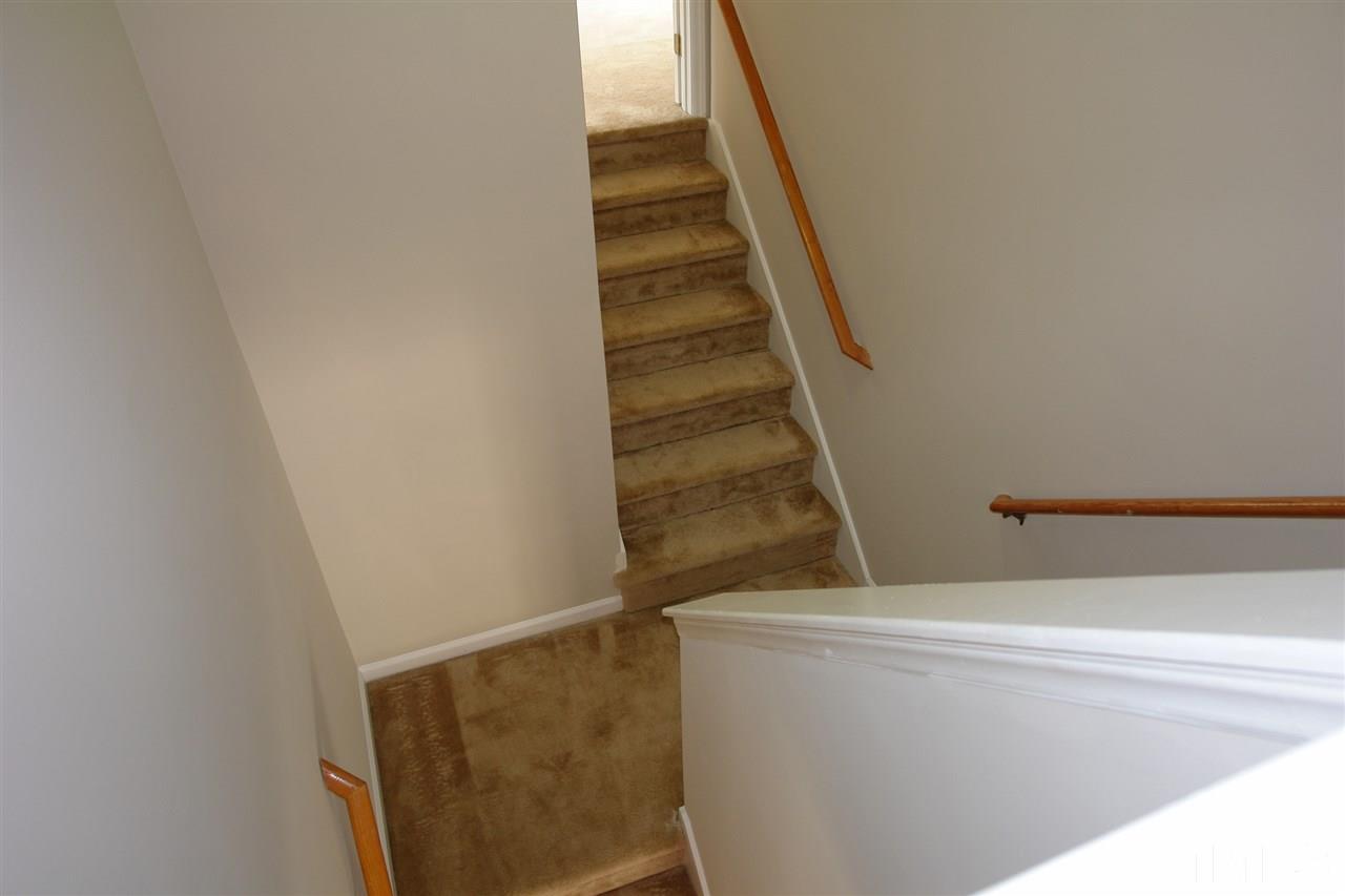 8317 Neuse Rapids Road Raleigh, NC 27616 - Photo 12 of 25 Stairs lead to the Large Bonus Room (toward the top of the photo) or toward the Bedrooms (toward the bottom of the photo).