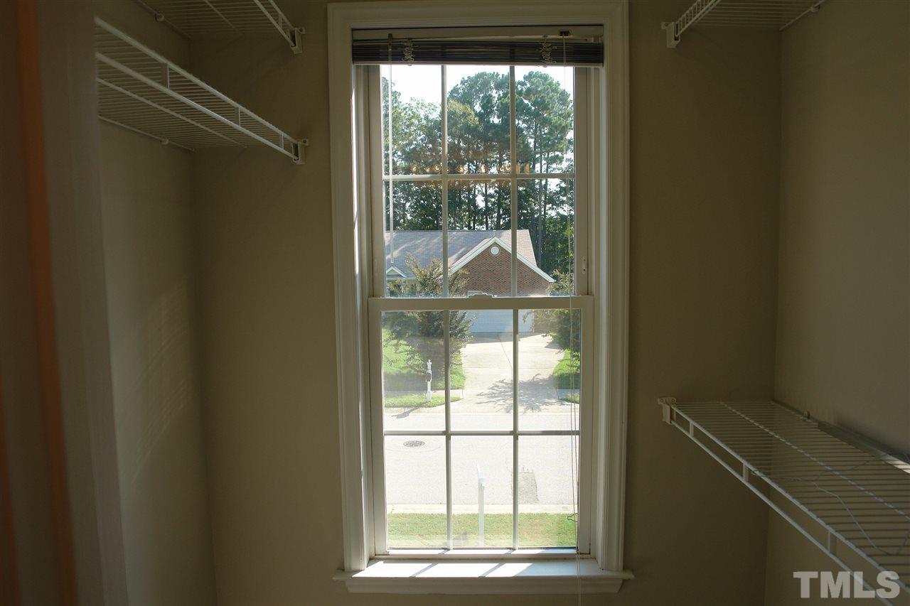8317 Neuse Rapids Road Raleigh, NC 27616 - Photo 16 of 25 Walk-in Closet in the Master Bathroom has beautiful light and view of the neighborhood. Sweet.