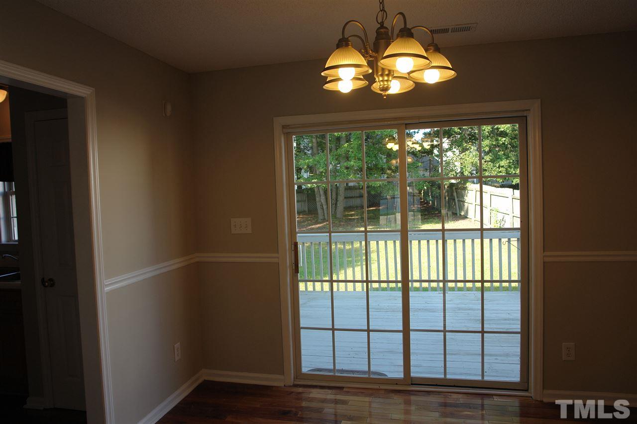 8317 Neuse Rapids Road Raleigh, NC 27616 - Photo 10 of 25 Dining Room with sliding glass doors looking into the fenced back yard over the deck space. Awesome!