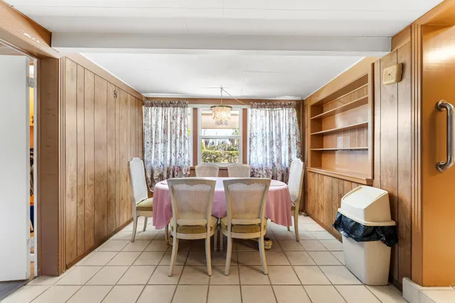 a dining room with furniture and a window