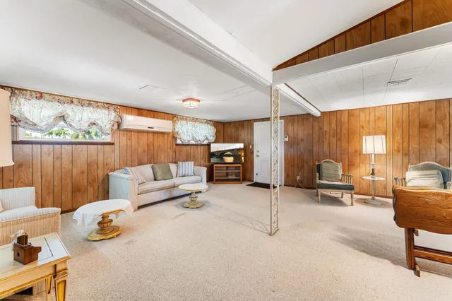 a bedroom with furniture and a large window