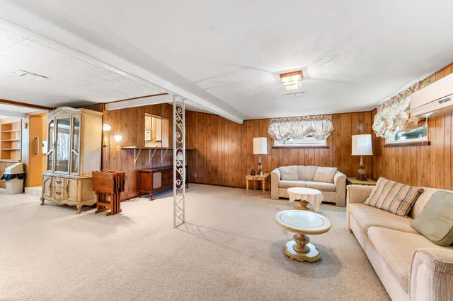 a living room with furniture and a lamp