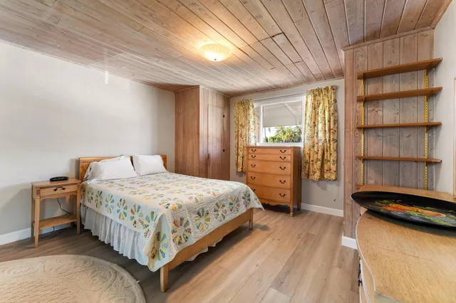 a bedroom with a bed closet and a window