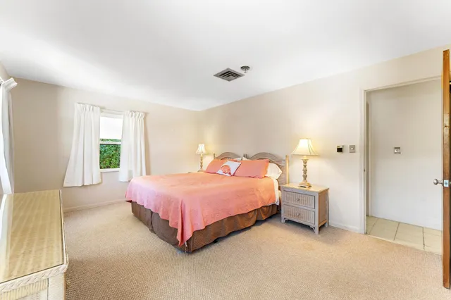 a spacious bedroom with a bed and a window