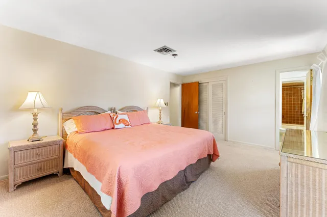 a bedroom with a bed and a night stand