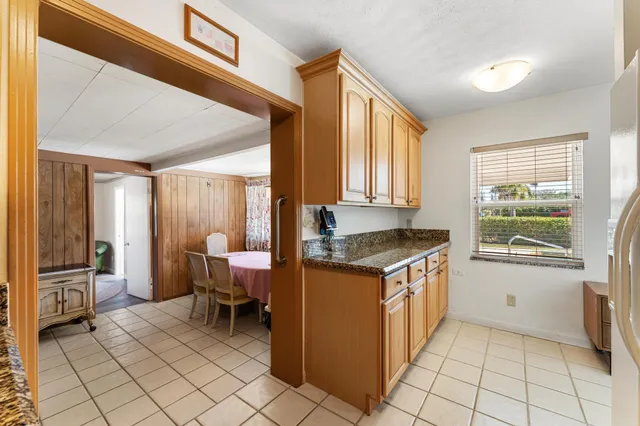 a kitchen that has a sink and chair