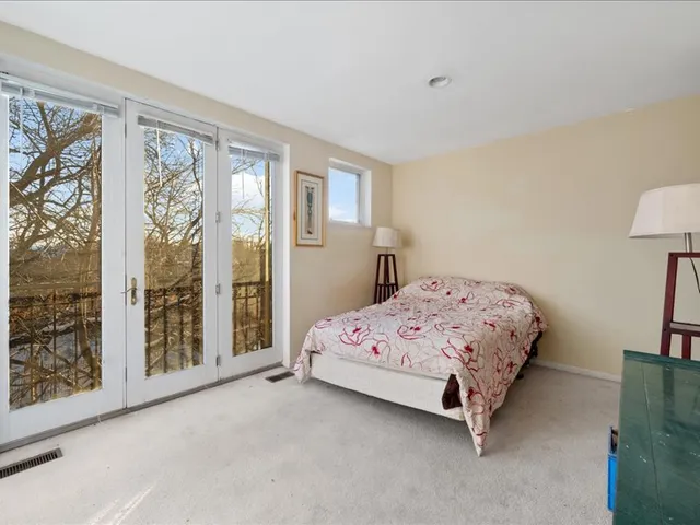 a bedroom with a large bed and a window