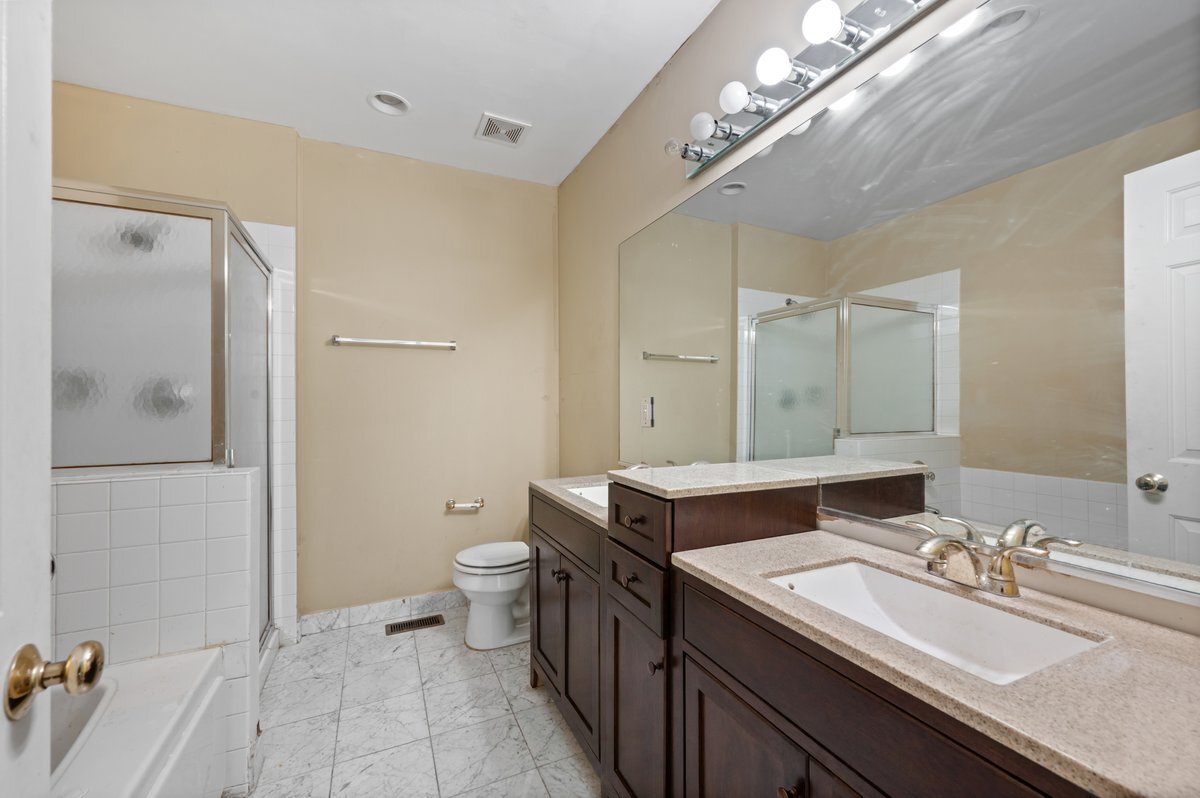 1412 West Diversey Parkway, Unit B Chicago, IL 60614 - Photo 15 of 26 a bathroom with a double vanity sink and a mirror