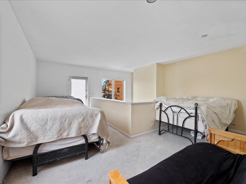 1412 West Diversey Parkway, Unit B Chicago, IL 60614 - Photo 16 of 26 a bedroom with a bed and a dresser