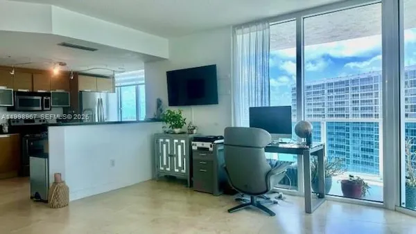 a livingroom with workspace and a window