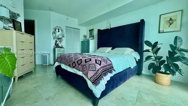 a bedroom with furniture and a potted plant