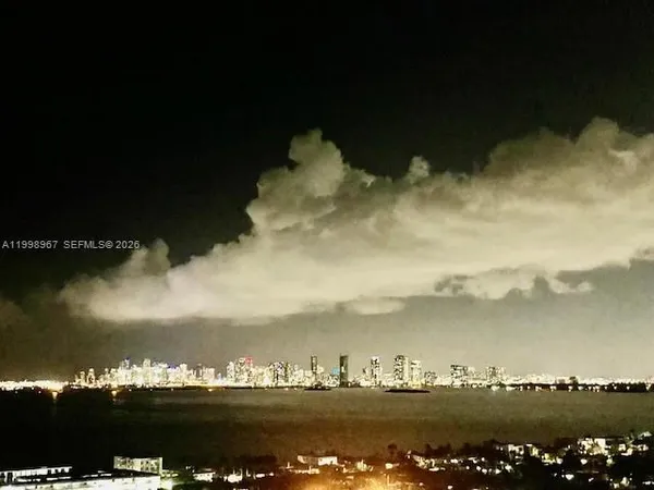 a view of a lake and yard from the back
