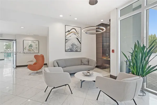a living room with furniture a rug and a potted plant
