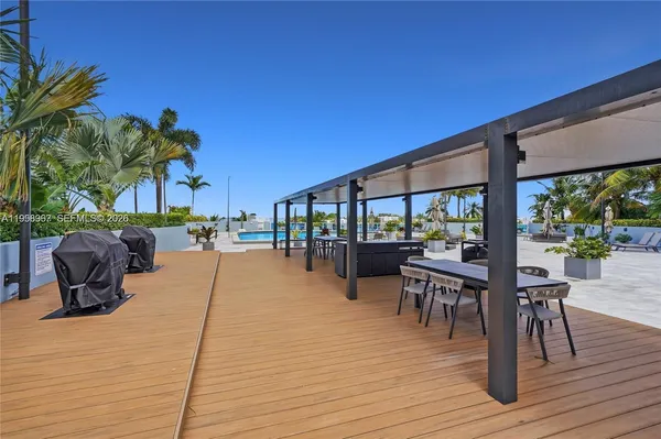 a swimming pool with outdoor seating and wooden floor