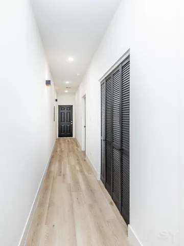 a bathroom with a double vanity sink a mirror and a bathtub