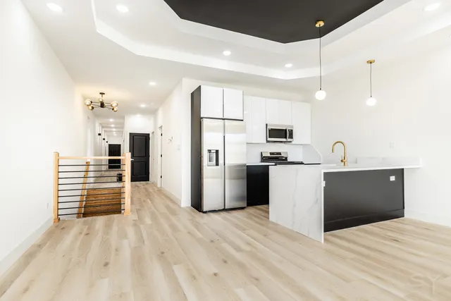 a kitchen with stainless steel appliances a refrigerator sink and microwave
