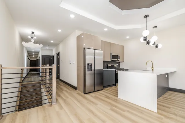 a view of kitchen with sink microwave and refrigerator