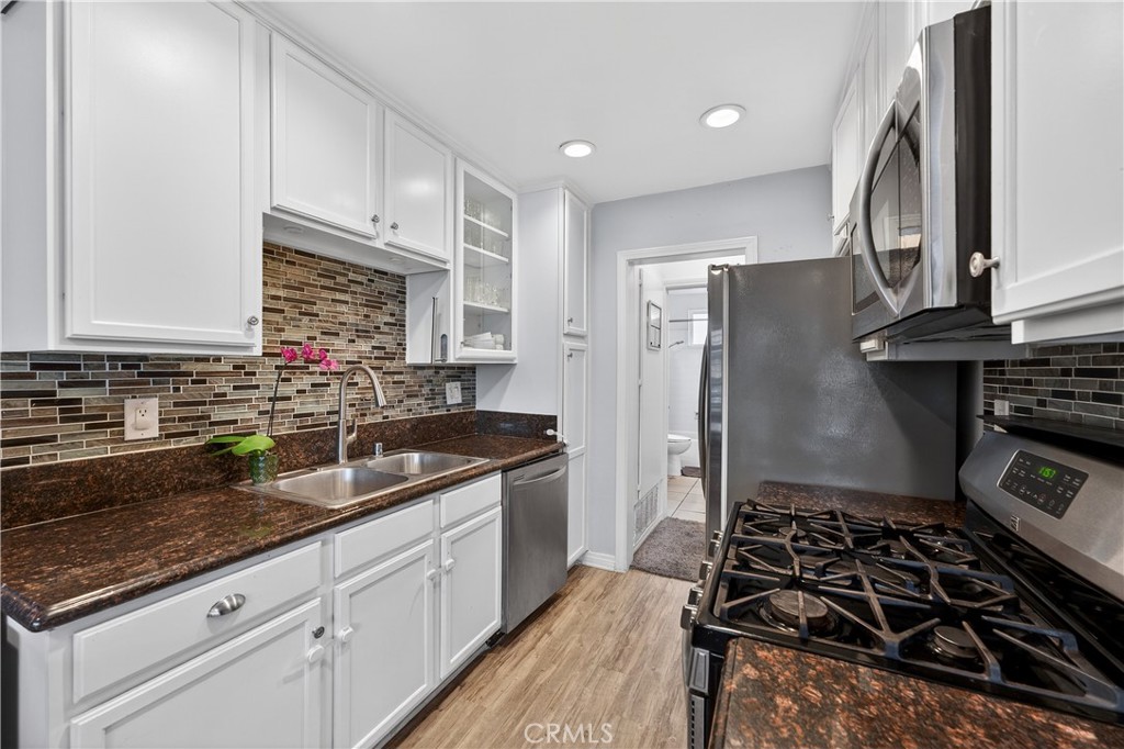1430 West Lambert Road, Unit 384 La Habra, CA 90631 - Photo 15 of 41 a kitchen with granite countertop a stove and a sink