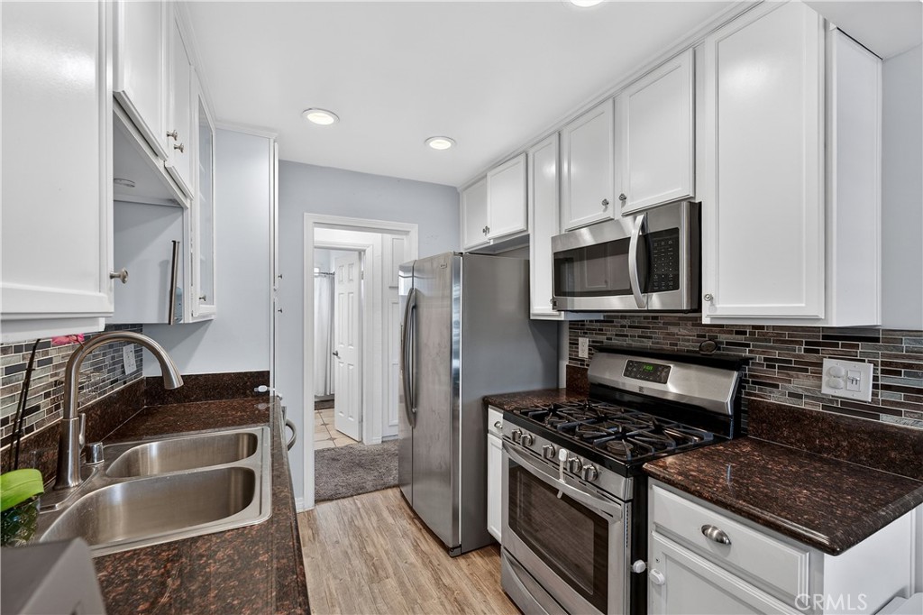 1430 West Lambert Road, Unit 384 La Habra, CA 90631 - Photo 16 of 41 a kitchen with granite countertop a sink stove and refrigerator