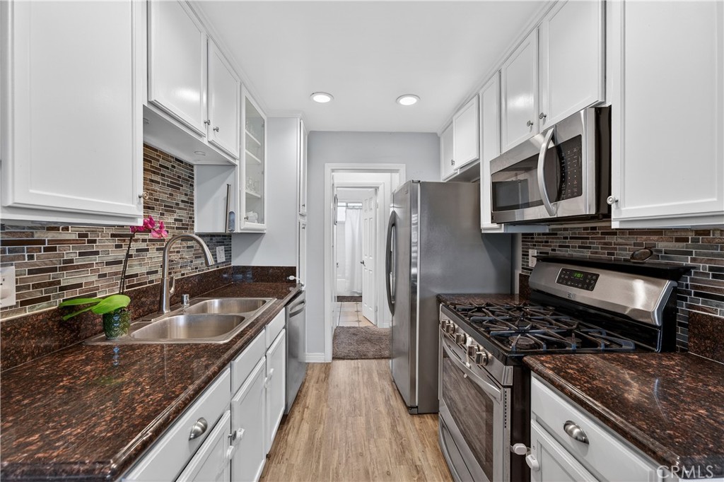 1430 West Lambert Road, Unit 384 La Habra, CA 90631 - Photo 17 of 41 a kitchen with stainless steel appliances granite countertop a sink stove and refrigerator