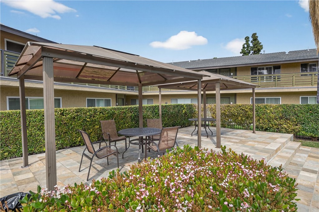 1430 West Lambert Road, Unit 384 La Habra, CA 90631 - Photo 21 of 41 a view of a patio with table and chairs and potted plants