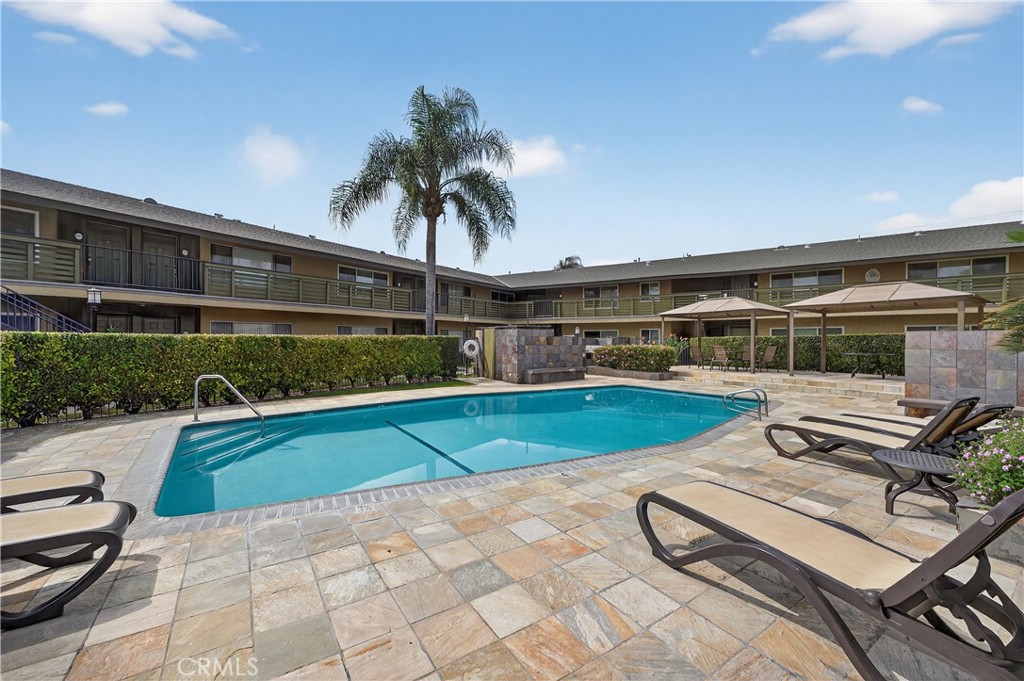 1430 West Lambert Road, Unit 384 La Habra, CA 90631 - Photo 23 of 41 a view of a swimming pool with a lounge chair
