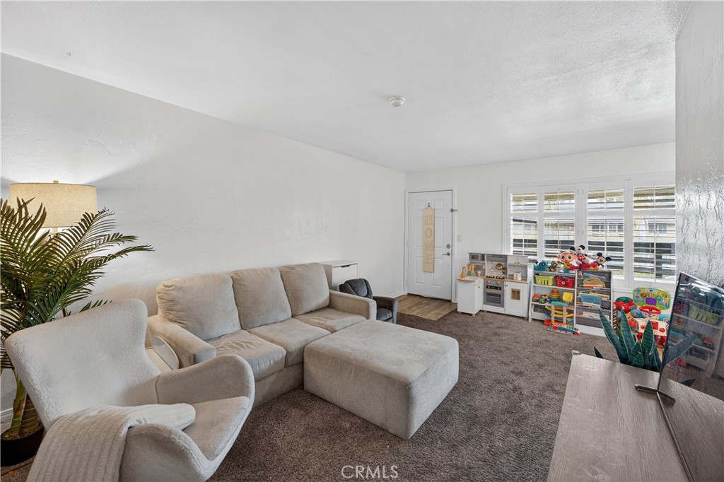 1430 West Lambert Road, Unit 384 La Habra, CA 90631 - Photo 3 of 41 a living room with furniture and a flat screen tv