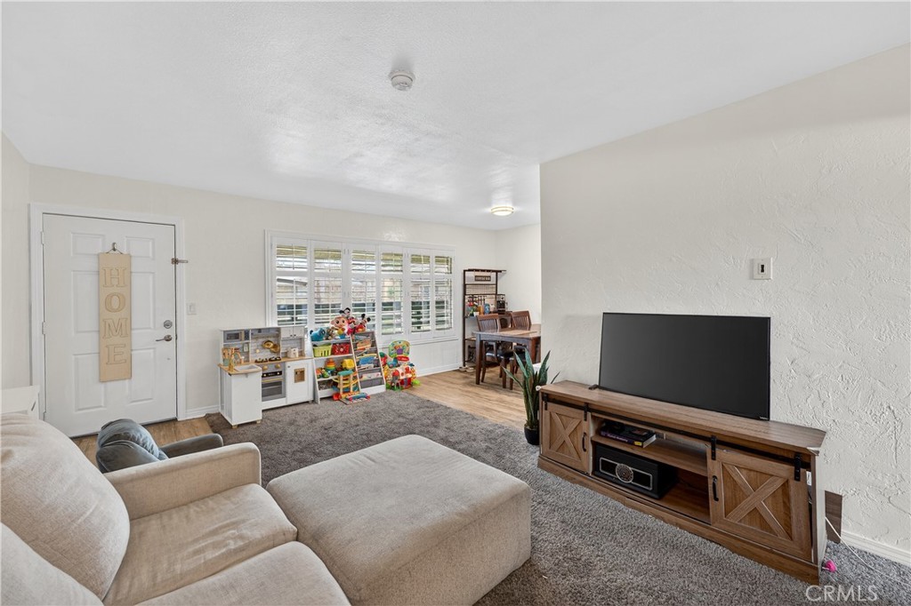 1430 West Lambert Road, Unit 384 La Habra, CA 90631 - Photo 5 of 41 a living room with furniture and a flat screen tv