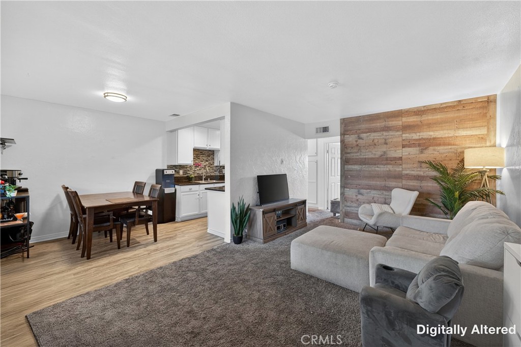 1430 West Lambert Road, Unit 384 La Habra, CA 90631 - Photo 7 of 41 a living room with furniture a flat screen tv and a fireplace